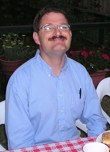 A recent photo of me sitting at a table.